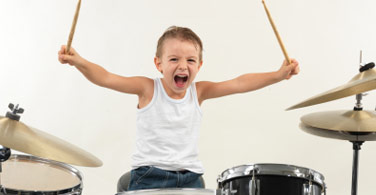 young boy playing the drums